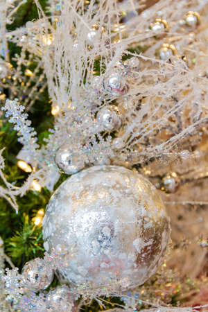 Silver Christmas Ornaments on a Christmas Treeの写真素材