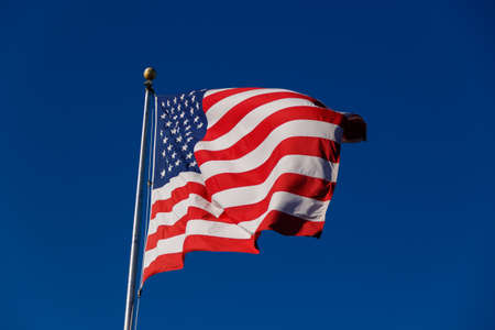 American Flag against blue sky.