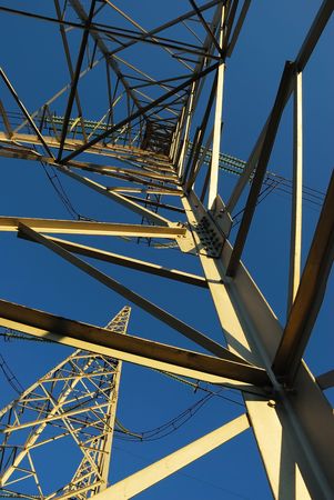 Bottom-up view of power lines on the blue sky background.の写真素材