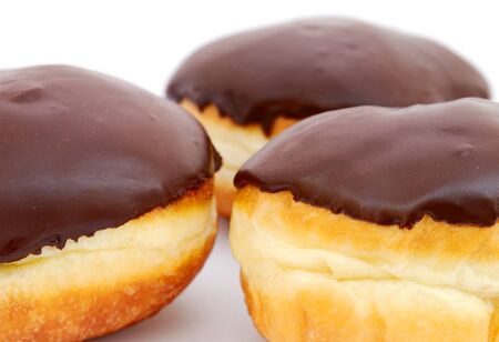 Close-up of chocolate doughnuts on white backgroundの写真素材