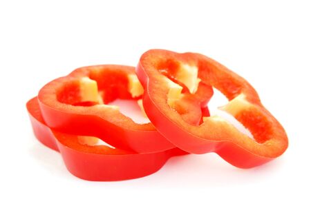 Slices of red bell pepper isolated on white backgroundの写真素材