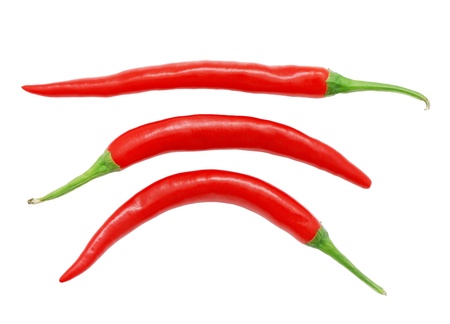 Three red hot chili peppers isolated on white backgroundの写真素材