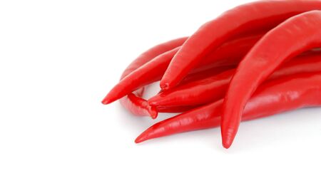 The heap of red hot chili peppers isolated on white backgroundの写真素材