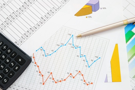 Finance documents with pen and calculatorの写真素材