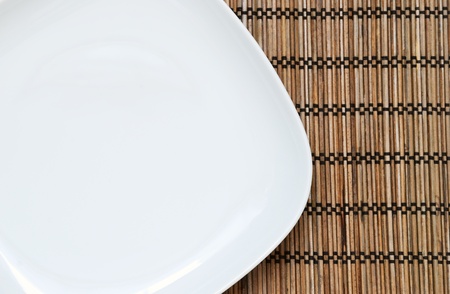 Empty plate on the bamboo napkin, top viewの写真素材