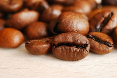 Closeup of coffee beans on a wooden tableの写真素材