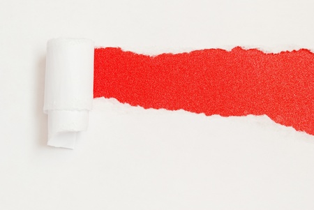 Ripped paper on red backgroundの写真素材