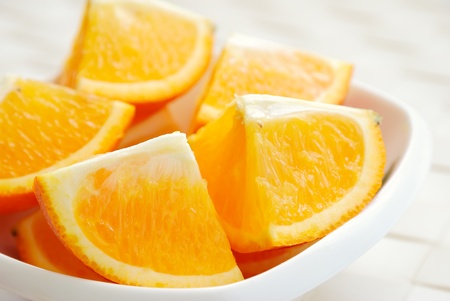 Close-up of sliced orange in the plateの写真素材