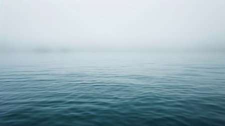 Calm body of water with a foggy sky in the backgroundの素材