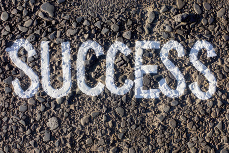 The word "Success" painted on the asphalt road, top viewの素材