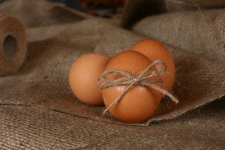 Fresh eggs on burlap. Rustic food. Home food decoration concept and idea.