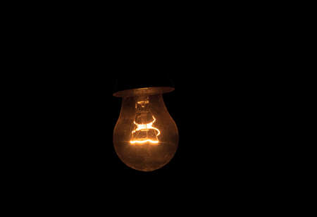 Vintage light bulb on black background with copy space. Idea concept.