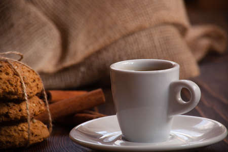 Cup of coffee with cookies on a wooden table. Selective focus.の写真素材