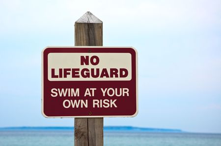 No lifeguard. Swim at your own risk  sign.の写真素材