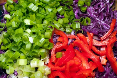 Chopped ingredients of salad. Green onions, sweet pepper, red cabbage.の写真素材