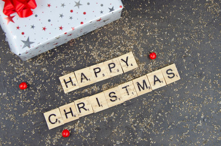 Red white christmas present and message with gold dustの写真素材