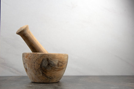 Wooden mortar and pestle set, copy space, marble backgroundの写真素材