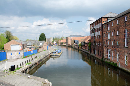 Old brick warehouses converted into lofts along a river on a sunny autumn day. River Trent, Newarkの写真素材