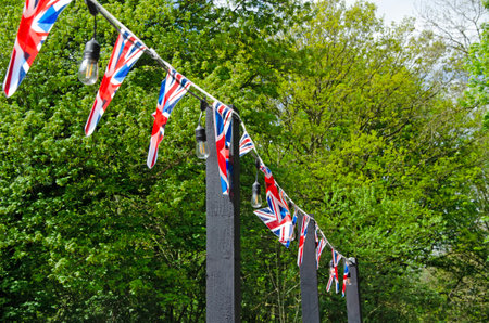Union flags bunting outdoors with trees in the backgroundの写真素材