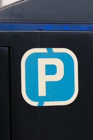 Parking sign on side of metal bin in the sunshine