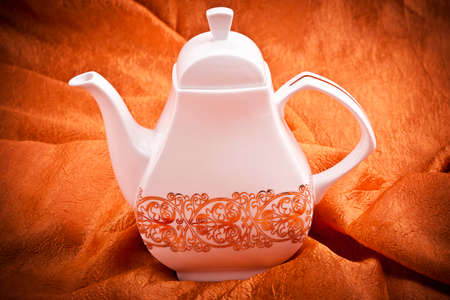 teapot isolated on orange fabric  backgroundの写真素材