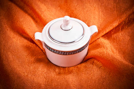 teapot isolated on orange fabric  backgroundの写真素材