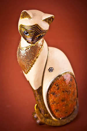 Cat  Sculpture on brown backgroundの写真素材
