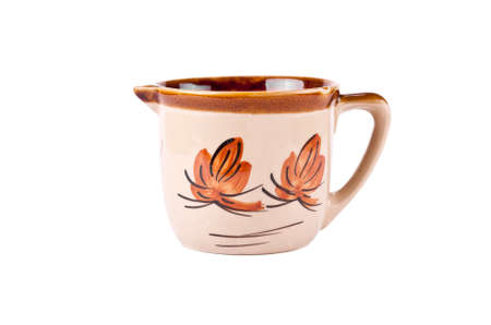 A pottery pitcher of milk on white backgroundの写真素材