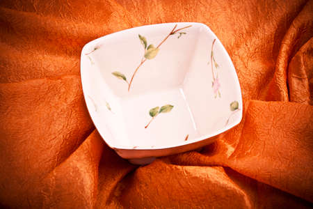 Ceramic brown dishware i on orange  backgroundの写真素材