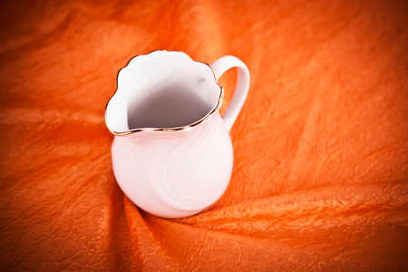 Sauce boat on  orange textile backgroundの写真素材