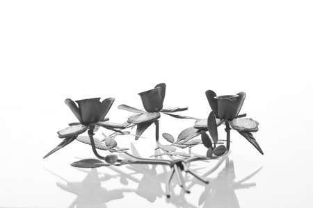 Triple iron caldlestick isolated on white background. の写真素材