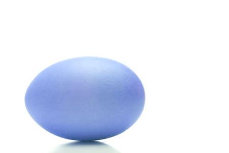 A dyed baby blue Easter egg on white backgroundの写真素材