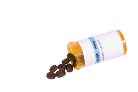 A medicine bottle with coffee beans isolated on white.