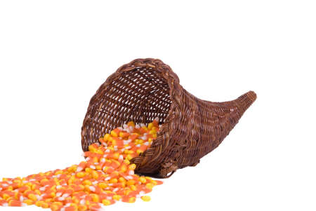 A wicker cornucopia filled with candy corn for Halloween.の写真素材