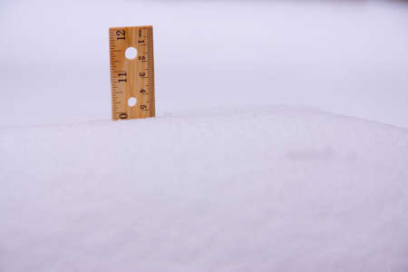 A ruler stuck in 10 inch deep snow.の写真素材