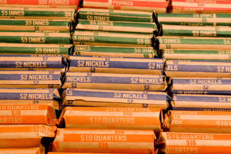 A collection of various rolled coins in wrappersの写真素材