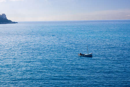 A man fishing on the Mediterranean in a small boatの写真素材