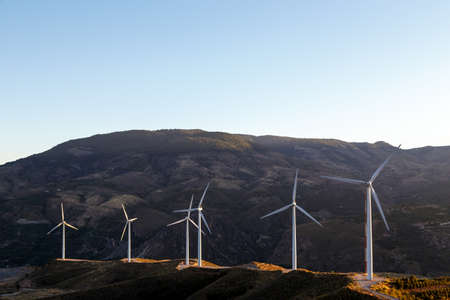view of some wind turbines in a wind farm on the mountainの写真素材