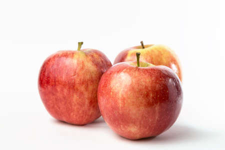 three red apples on white backgroundの写真素材