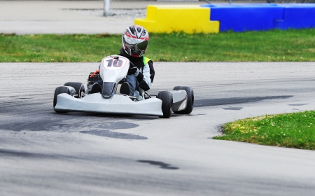 Teenage racer on a Yamaha engined sprint kart on a road racing circuit 
