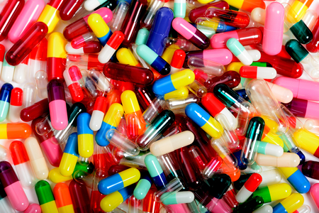 Empty medicinal capsules in varying colors, sizes and styles.の写真素材