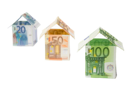 Three houses made of different euro bills isolated on white backgroundの写真素材