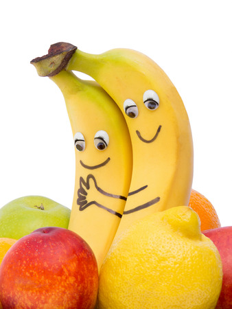 Two loving bananas with eyes and mouthの写真素材