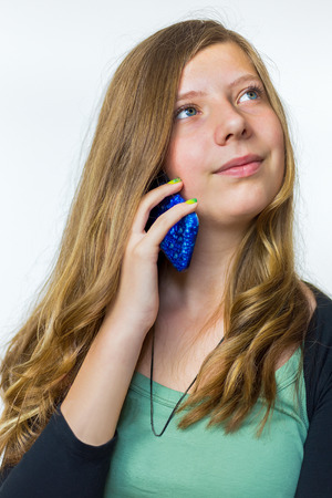 Blonde caucasian teenage girl phoning with mobile telephoneの写真素材
