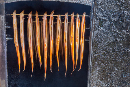 Row smoked eels hanging fish