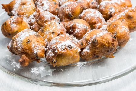 Many fritters or oliebollen with icing sugar on glass scaleの写真素材