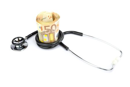 Stethoscope wrapped around roll of euro billsの写真素材
