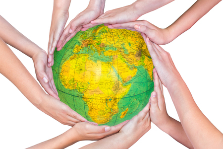 Many arms of children with hands holding globe with planet earthの写真素材