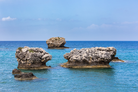 Three separate rocks offshore in blue greek oceanの写真素材