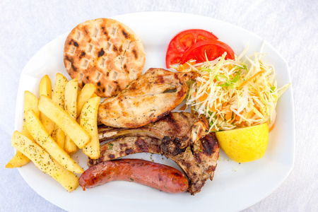Dinner with vegetables fruits meat and french fries